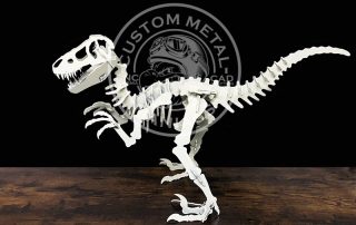 T rex skeleton made of metal bone parts standing on table against dark background